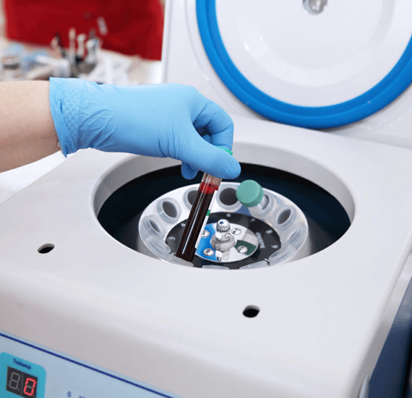 image showing clinician placing a tube into a centrifuge