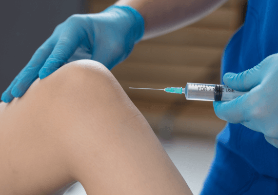 Image showing an injection into the knee as patient is lying down
