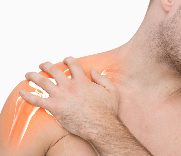 image of man holding shoulder in pain
