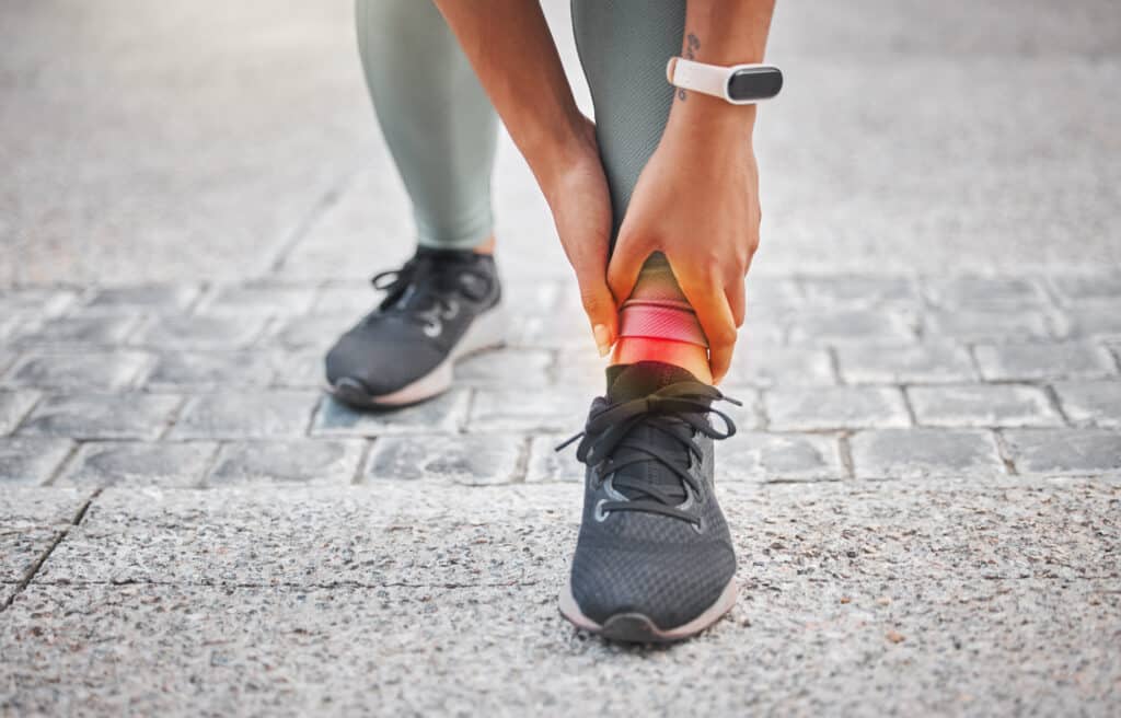 picture of woman holding Ankle due to pain caused by ankle impingement